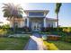 Exterior view of the Sports Center Clubhouse with lush landscaping, a brick path, and a modern entrance at 16127 Fortezza Dr, Bradenton, FL 34211