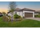 Well-maintained home with a tiled roof, lush lawn, and manicured landscaping at 16127 Fortezza Dr, Bradenton, FL 34211