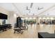 The fitness center with free weights, a wood floor, ceiling fans, and a wall mirror at 16127 Fortezza Dr, Bradenton, FL 34211