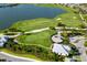 Aerial view of golf course with green fairways, a lake and stunning landscaping at 16127 Fortezza Dr, Bradenton, FL 34211
