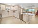 Bright kitchen featuring white cabinets, stainless steel appliances, and a center island at 16127 Fortezza Dr, Bradenton, FL 34211