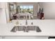 Bright kitchen featuring white cabinets, stainless steel appliances, and a center island, overlooking great room at 16127 Fortezza Dr, Bradenton, FL 34211
