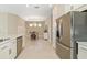 Contemporary kitchen overlooking the dining area with stainless appliances and white cabinetry at 16127 Fortezza Dr, Bradenton, FL 34211