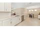 Bright kitchen with stainless steel appliances and white cabinets, open to the dining area at 16127 Fortezza Dr, Bradenton, FL 34211