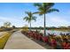 Scenic view of a beautifully landscaped community with a sidewalk alongside a pond at 16127 Fortezza Dr, Bradenton, FL 34211