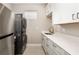 Well-equipped laundry room with stacked washer/dryer and ample counter space at 16127 Fortezza Dr, Bradenton, FL 34211