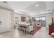 Bright living room boasts tile flooring, tray ceiling, and access to a screened patio at 16127 Fortezza Dr, Bradenton, FL 34211