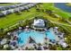 Stunning aerial view of a community pool with palm trees and lounge chairs at 16127 Fortezza Dr, Bradenton, FL 34211