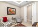 Cozy sitting room featuring stylish plaid armchairs, a striking art piece, and a neutral color palette at 16127 Fortezza Dr, Bradenton, FL 34211