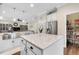 Bright kitchen with a stainless steel sink, white cabinets, and a walk-in pantry at 5726 Aaron Ct, Sarasota, FL 34232