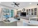 Comfortable living room with neutral decor, large windows, and access to the screened pool area at 5726 Aaron Ct, Sarasota, FL 34232