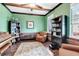 Cozy home office with exposed beams, rustic accents, and ample shelving at 5726 Aaron Ct, Sarasota, FL 34232