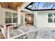 Outdoor patio features a dining table with seating and a view of the indoor kitchen at 5726 Aaron Ct, Sarasota, FL 34232