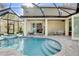 Inviting screened-in pool area with a spa, patio, and access to the home's interior at 5726 Aaron Ct, Sarasota, FL 34232