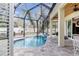 Inviting screened-in pool and spa with tile surround, creating a serene backyard oasis at 5726 Aaron Ct, Sarasota, FL 34232