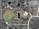 Aerial view of an expansive property with ponds, mature trees, and a beautiful Mediterranean-style home and pool at 1450 Bern Creek Loop, Sarasota, FL 34240