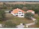 Mediterranean-style estate with a red tile roof, screened pool, and a gated entrance on lush acreage at 1450 Bern Creek Loop, Sarasota, FL 34240