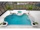 Beautiful enclosed pool area with steps and tiled deck is surrounded by screened enclosure and green outdoor views at 1450 Bern Creek Loop, Sarasota, FL 34240