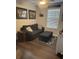 Cozy bedroom with dark blue loveseat and dark wooden floors at 16154 Monterey Greens Cir, Tampa, FL 33647