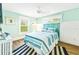 Bright bedroom with blue accents, coastal artwork, and wood-look floors at 213 84Th St, Holmes Beach, FL 34217