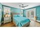Cozy bedroom featuring a comfortable bed, soft lighting, and access to a private balcony at 213 84Th St, Holmes Beach, FL 34217