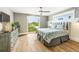Coastal bedroom featuring balcony access, wood floors, and soothing neutral decor at 213 84Th St, Holmes Beach, FL 34217