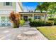 Inviting front porch with a wood door, featuring lush landscaping and a brick pathway leading up to the entrance at 213 84Th St, Holmes Beach, FL 34217