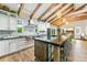 Well-appointed kitchen with custom cabinets, a large center island, and stainless steel appliances at 213 84Th St, Holmes Beach, FL 34217