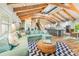Open-concept living room with vaulted ceiling, exposed beams, and stylish decor with view to kitchen at 213 84Th St, Holmes Beach, FL 34217