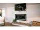 Modern living room features a fireplace with a live-edge mantle and a wall-mounted television at 213 84Th St, Holmes Beach, FL 34217