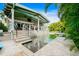 Beautiful outdoor living space featuring a pool, spa, and a built-in stone waterfall feature at 213 84Th St, Holmes Beach, FL 34217