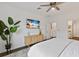 Light bedroom has a flat screen TV, plant in corner, and closet access at 3409 Anchor Bay Trl, Lakewood Ranch, FL 34211