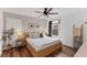 This bedroom features a modern bed frame with an en-suite bathroom and natural light at 3409 Anchor Bay Trl, Lakewood Ranch, FL 34211