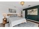 This is a bedroom with a decorative light fixture and accent wall with eye-catching art pieces at 3409 Anchor Bay Trl, Lakewood Ranch, FL 34211