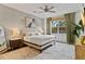 Bright bedroom features a ceiling fan, a large window and a textured accent wall above the bed at 3409 Anchor Bay Trl, Lakewood Ranch, FL 34211
