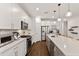 Modern kitchen with white cabinetry, stainless steel appliances, and an island, seamlessly blending style with functionality at 3409 Anchor Bay Trl, Lakewood Ranch, FL 34211