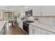 Well-lit kitchen with white cabinets, stainless steel appliances, and a breakfast nook, perfect for modern living and dining at 3409 Anchor Bay Trl, Lakewood Ranch, FL 34211
