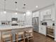 Contemporary kitchen with white cabinetry, stainless steel appliances, and a stylish island, perfect for cooking and entertaining at 3409 Anchor Bay Trl, Lakewood Ranch, FL 34211