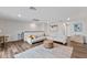 Upstairs living room offers a sectional sofa, area rug, and views of the surrounding neighborhood at 3409 Anchor Bay Trl, Lakewood Ranch, FL 34211