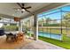 This covered patio boasts beautiful pool views, a ceiling fan, and ample seating space at 3409 Anchor Bay Trl, Lakewood Ranch, FL 34211