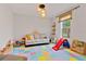 Bright playroom with colorful floor tiles, a comfortable couch, and fun toys for  at 3409 Anchor Bay Trl, Lakewood Ranch, FL 34211