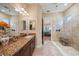 Bright bathroom features double sinks, a vanity with granite countertops, and a glass-enclosed shower at 3904 Waypoint Ave, Osprey, FL 34229