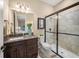 Modern bathroom features a dark vanity with granite countertops and a glass-enclosed shower at 3904 Waypoint Ave, Osprey, FL 34229
