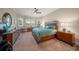 Serene bedroom retreat with a tray ceiling, large windows, and luxurious furnishings at 3904 Waypoint Ave, Osprey, FL 34229