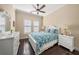 Comfortable bedroom with a ceiling fan, white furniture, and bright windows for natural light at 3904 Waypoint Ave, Osprey, FL 34229