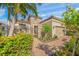 Charming stone house showcasing lush landscaping and a private gated entrance at 3904 Waypoint Ave, Osprey, FL 34229