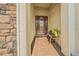 Inviting front entrance with a stone accent wall, brick walkway, and a decorative bench at 3904 Waypoint Ave, Osprey, FL 34229