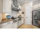 Modern kitchen featuring stainless steel appliances, granite countertops, and ample cabinet space at 3904 Waypoint Ave, Osprey, FL 34229