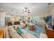 Bright living room featuring a ceiling fan, a blue rug, and sliding glass doors to an outdoor space at 3904 Waypoint Ave, Osprey, FL 34229