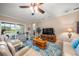 Inviting living room with a patterned rug, ceiling fan, and sliding doors to an outdoor living space at 3904 Waypoint Ave, Osprey, FL 34229